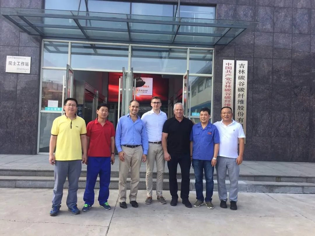Nicolas Wegener and Greg LeMond with the team outside the Jilin Carbon Valley carbon fiber plant in China, August 2017