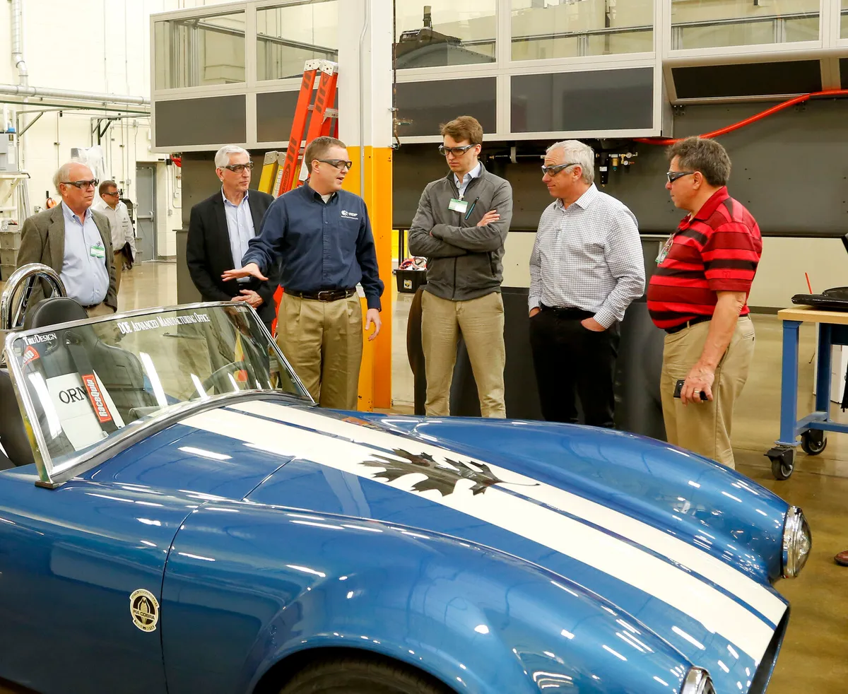 Nicolas Wegener and colleagues beside the 3D-printed carbon fiber Shelby Cobra at Oak Ridge National Laboratory, 2015