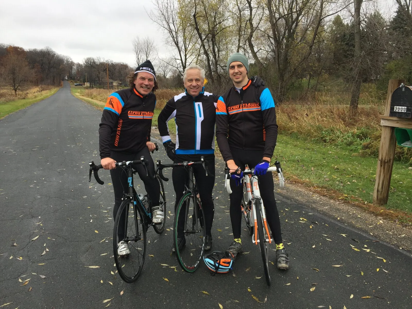 Nicolas Wegener riding with Greg LeMond and a teammate on a road in autumn