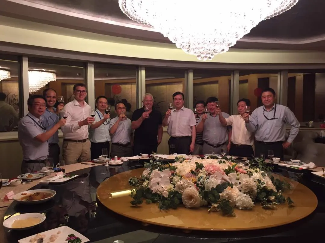 Nicolas Wegener, Greg LeMond and hosts raising a toast at a dinner in the Sinopec tower, China, August 2017